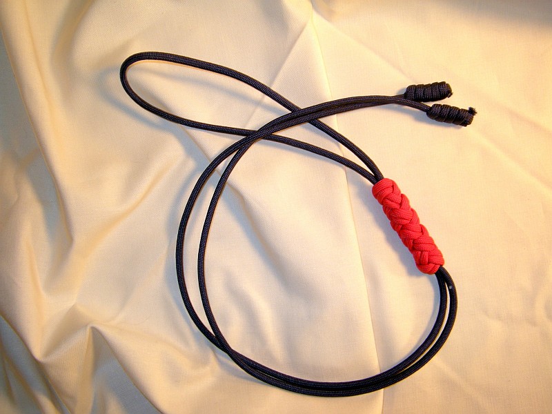 A Bolo Tie Made From Dark Blue And Red Paracord, A Turk's Head Forms The  Slider