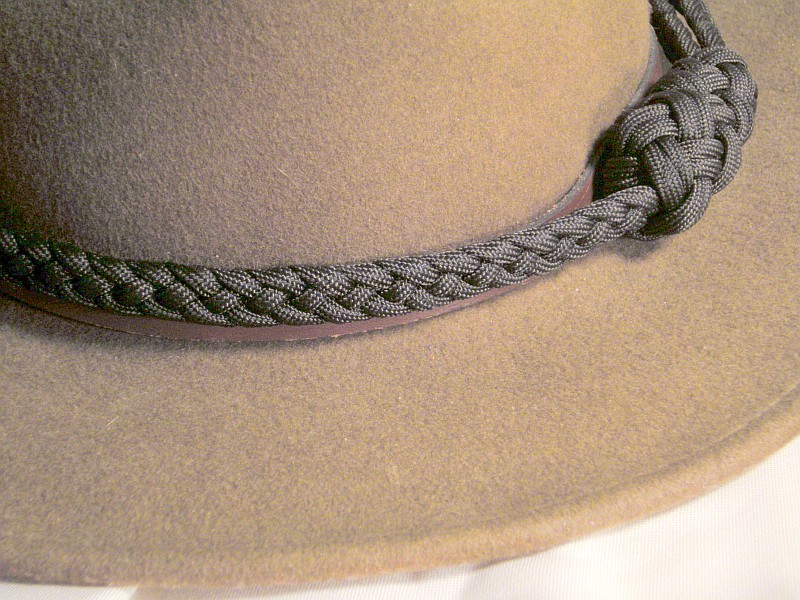A Dress Wear Hat Band Made Out Of A Four Strand Flat Braid In Black Paracord