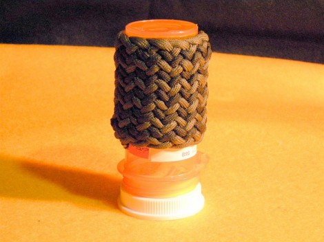 Medicine Bottle #43; covered by a bi-colored, 2" long Pineapple knot variation.