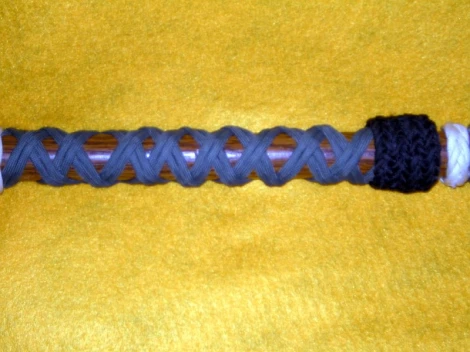 An 11 Part X 2 Bight Turk's Head knot on a walking stick.